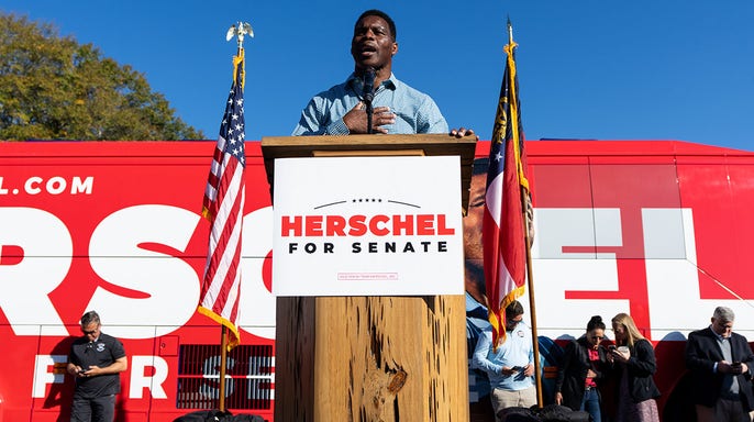 Warnock’s campaign bus has a Tennessee license plate, and Herschel criticizes it